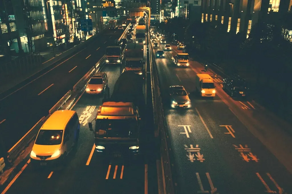 The same street at night through a LumaNight camera: the yellow taxis and tail-lights clearly visible in colour